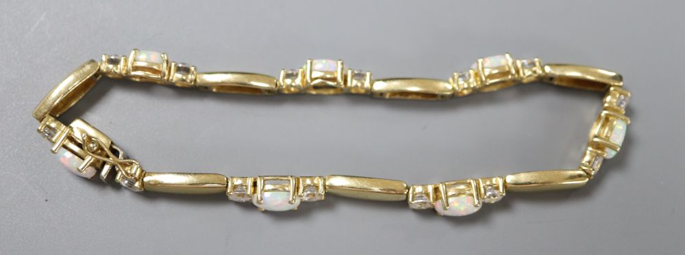 A pair of 585, white opal and paste stud earrings and a similar paste-set bracelet and ring ensuite, gross 21.6g.